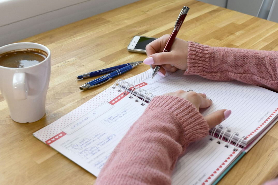 blogger writing in notebook