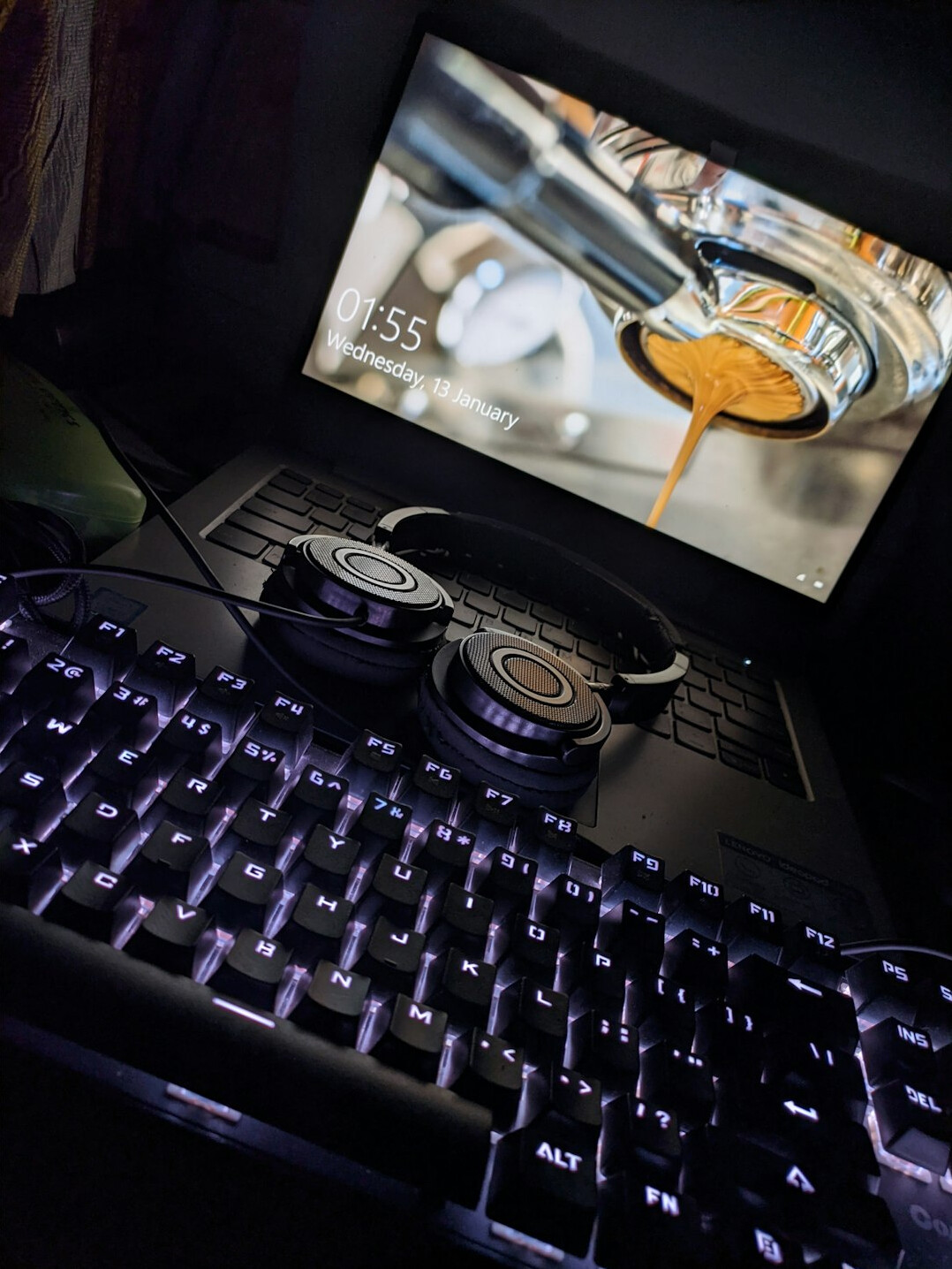 Laptop screen showing audio editing software with a sound waveform