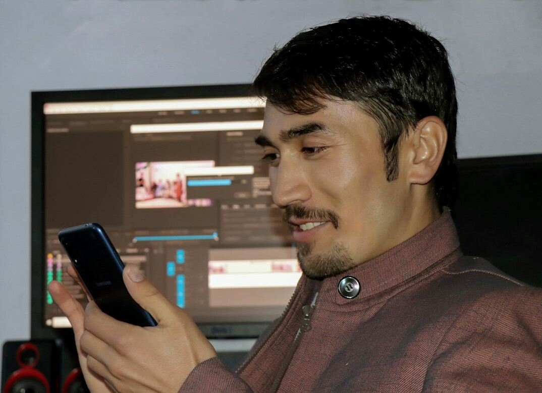 man editing audio on computer