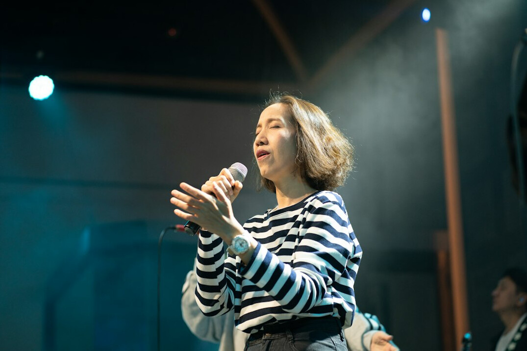 woman speaking into microphone